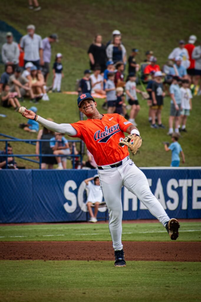 Fielder in orange stretching to make a throw