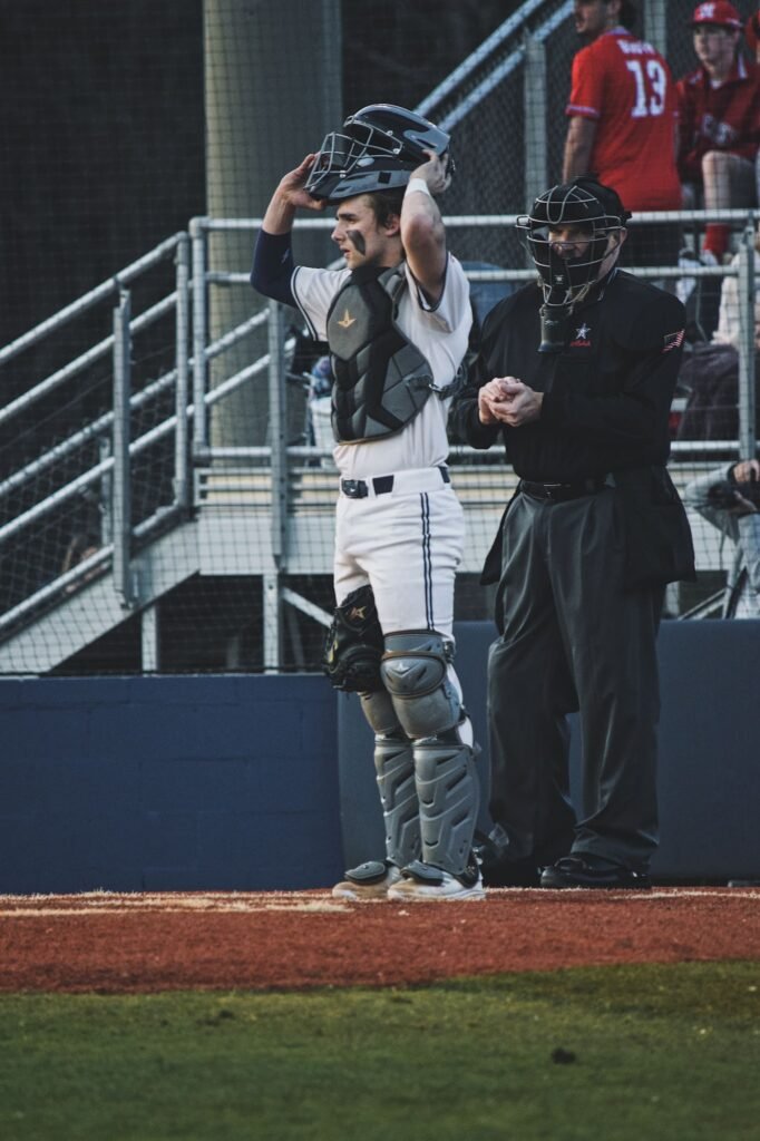 Catcher and umpire watching the field from behind the plate