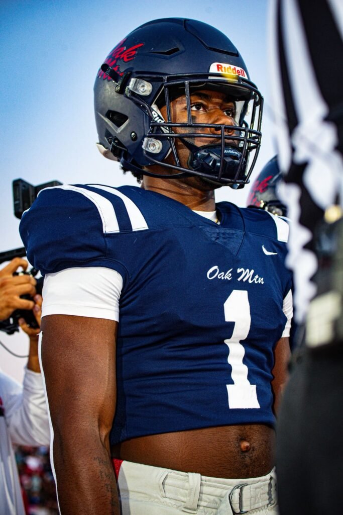 Player in a navy number 1 jersey and helmet on the sideline